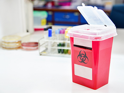 Small medical waste bin sitting on a table