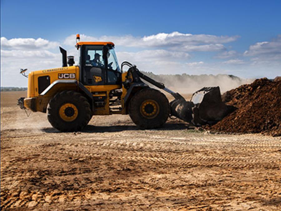Tractor pushing debris into a pile